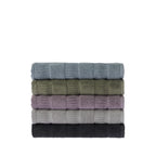 Stack of five folded Design Republique Addison textured bath towels in faded blue, khaki, grape, silver and charcoal, showing the soft cotton texture and striped detailing.