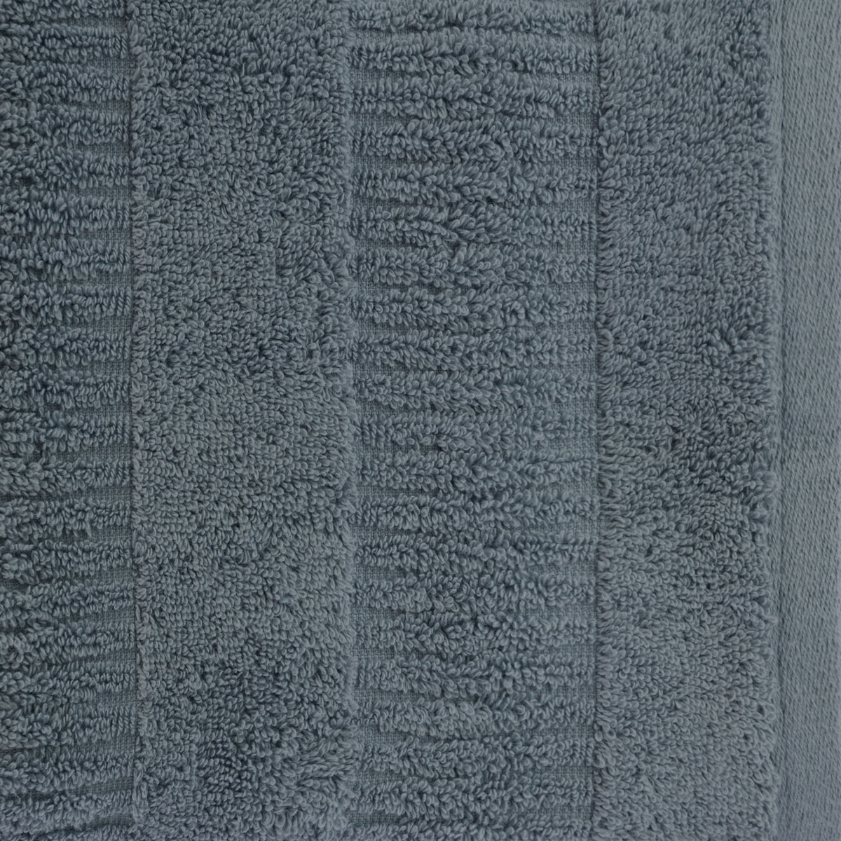 Close-up of a faded blue Design Republique Addison textured hand towel showing the plush cotton pile and textured stripe pattern.