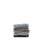Stack of five folded Design Republique Addison textured face cloths in faded blue, khaki, grape, silver and charcoal, showing the plush cotton texture and coordinating stripe design.