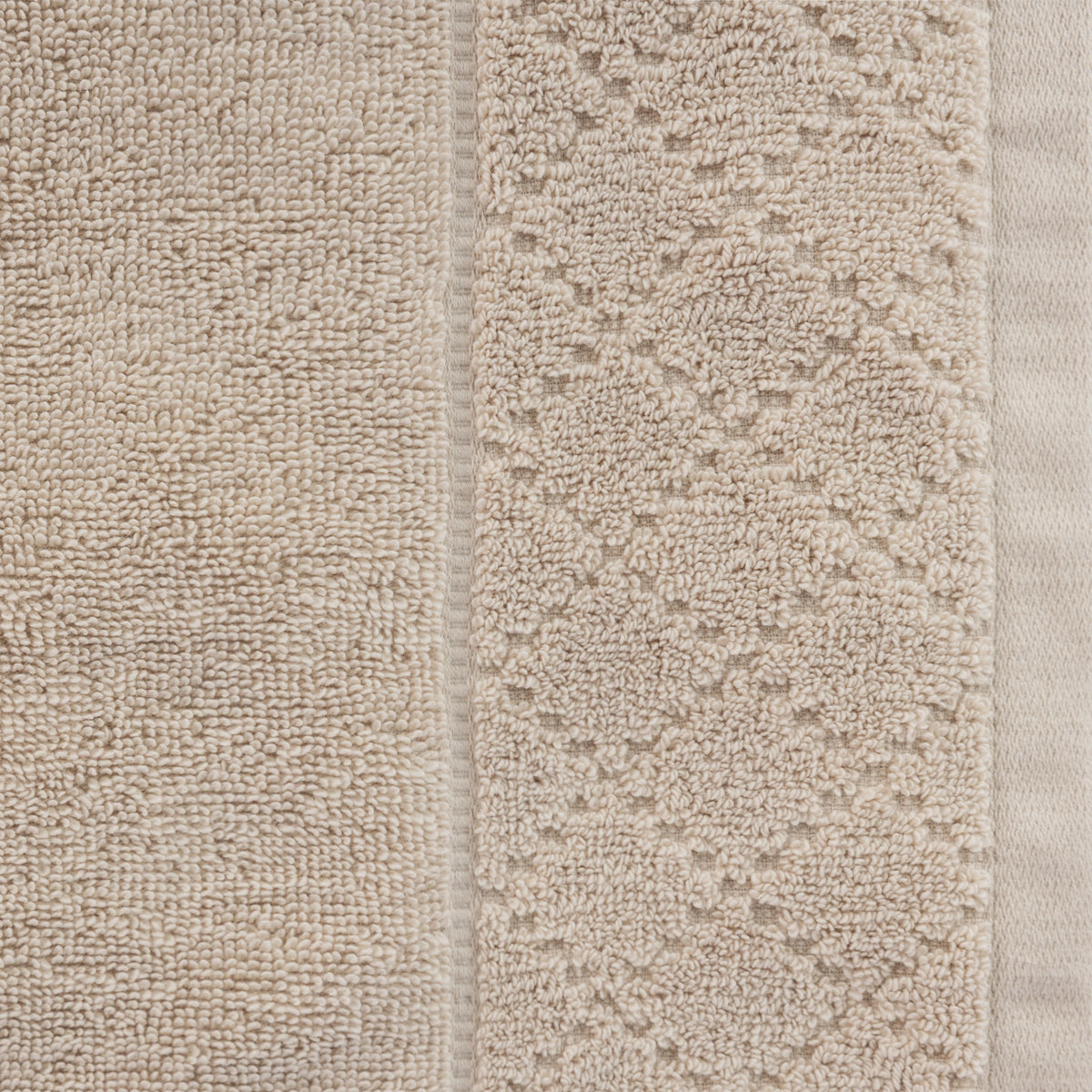 Close-up of the Gracious Living Marilyn Bath Sheet in taupe, showing the soft looped cotton surface and decorative woven border.