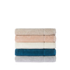 Stack of five Gracious Living Marilyn bath towels in beige, peach, white, teal and silver, neatly folded to display the soft cotton texture and patterned borders.