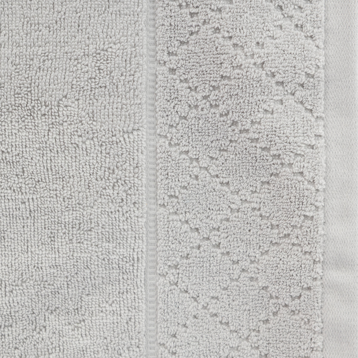 Close-up of the Gracious Living Marilyn Face Cloth in silver, highlighting the soft looped texture and patterned border detail.
