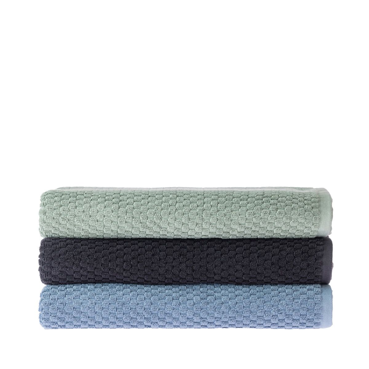 Three folded Quinny Popcorn bath sheets stacked in Sea Mist, Charcoal and Denim, featuring a raised textured pattern and plain woven borders.