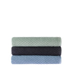Three folded Quinny Popcorn bath towels stacked in Sea Mist, Charcoal and Denim, showing the soft raised woven texture.