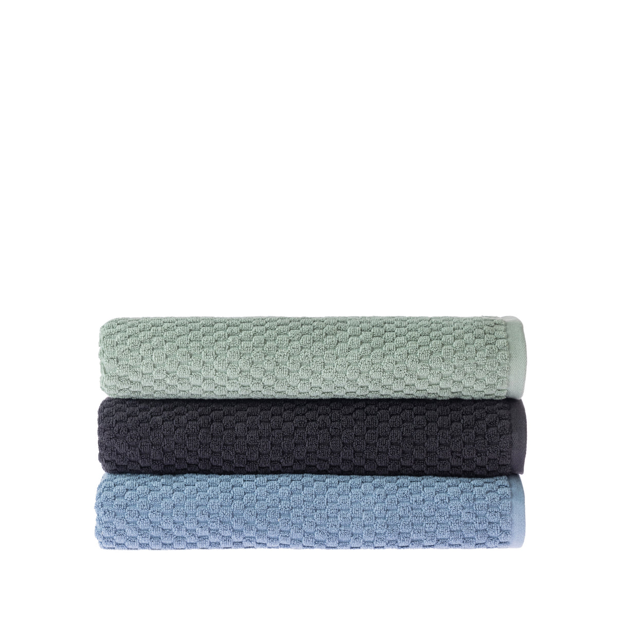 Three folded Quinny Popcorn bath towels stacked in Sea Mist, Charcoal and Denim, showing the soft raised woven texture.