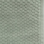 Close-up of the Design Republique Quinny Popcorn Bath Towel in Sea Mist, highlighting the textured raised loop design and coordinating border.