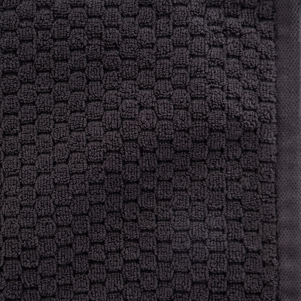 Close-up of the Design Republique Quinny Popcorn Hand Towel in Charcoal, highlighting the raised loop texture and dark charcoal finish.