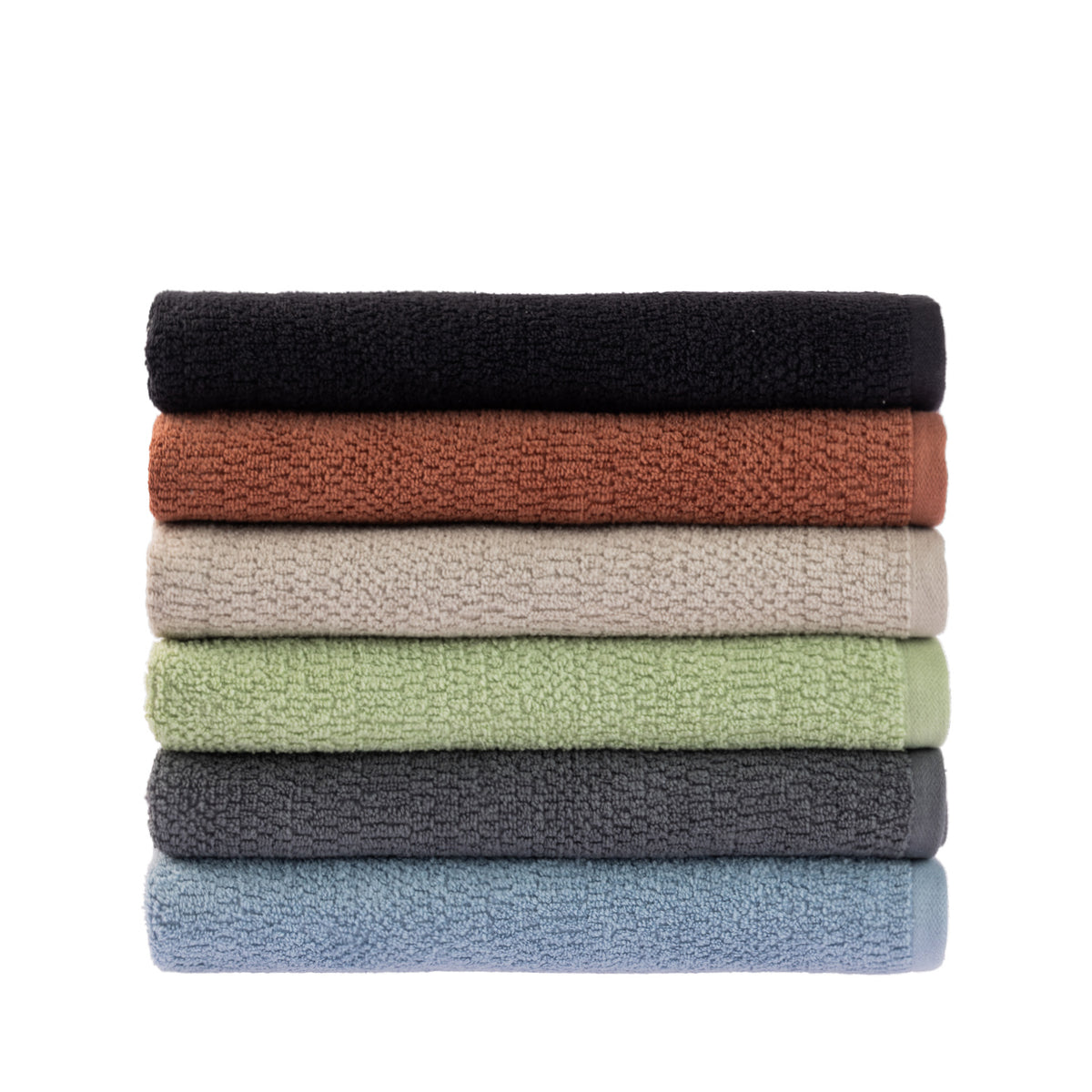 A neatly stacked collection of Home Co. Nevada Bath Towels featuring a textured cotton finish in black, rust, beige, sage green, charcoal and pale blue, displayed against a white background.