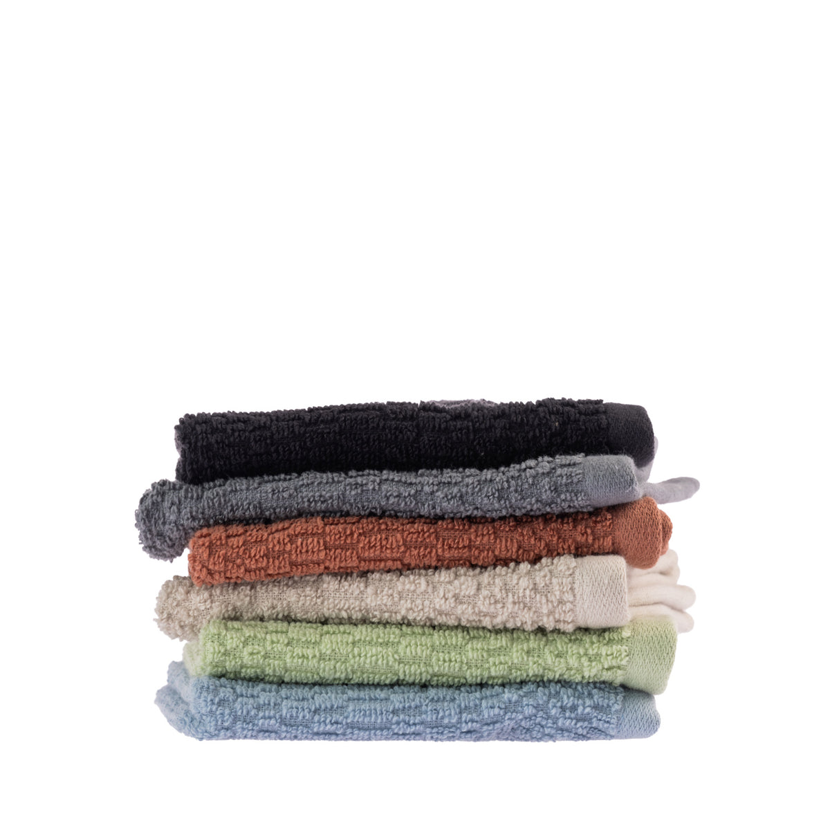 A collection of Home Co. Nevada Face Cloths featuring a textured cotton design in black, charcoal, rust, beige, sage green and pale blue, neatly stacked against a white background.