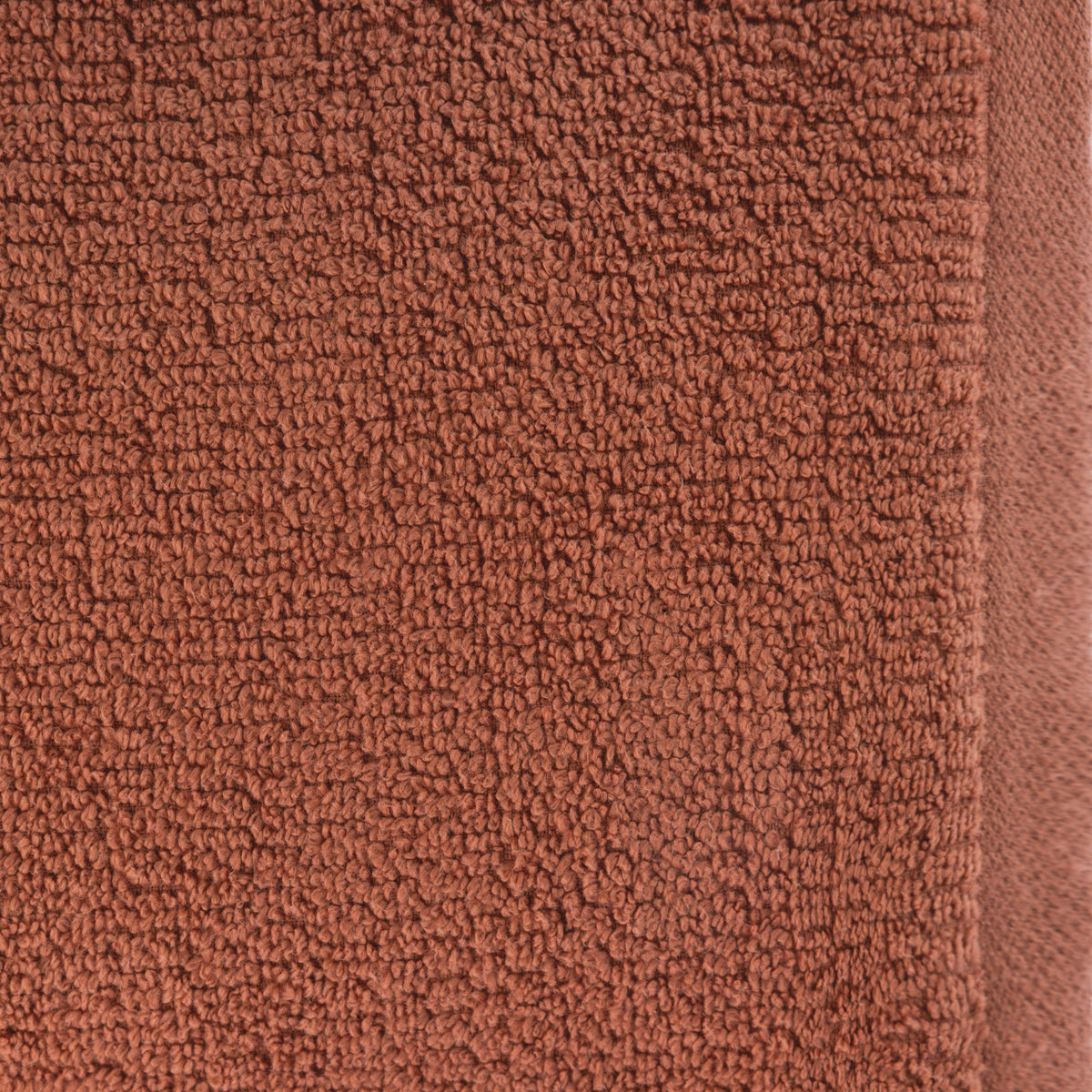 A close-up of the Home Co. Nevada Face Cloth 390gsm in Clay, showcasing the warm earthy rust colour, textured cotton loops and smooth woven edging.