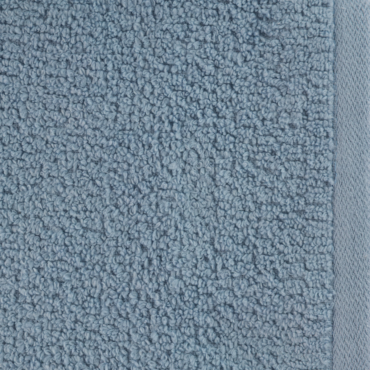 A close-up of the Home Co. Nevada Face Cloth 390gsm in Pale Blue, featuring a soft textured cotton surface with raised loops and a neatly woven border.