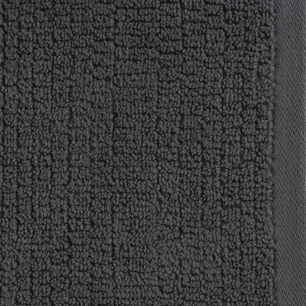 A close-up of the Home Co. Nevada Bath Towel 390gsm in Steel, featuring a deep charcoal grey colour, textured cotton weave and smooth woven edging.