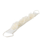 An ivory sash with a cascading ruffled fabric flower design and braided tie ends, shown on a plain white background.