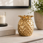 Design Republique Pippa Pineapple Vase in gold, styled on a tabletop with a glossy metallic pineapple design.