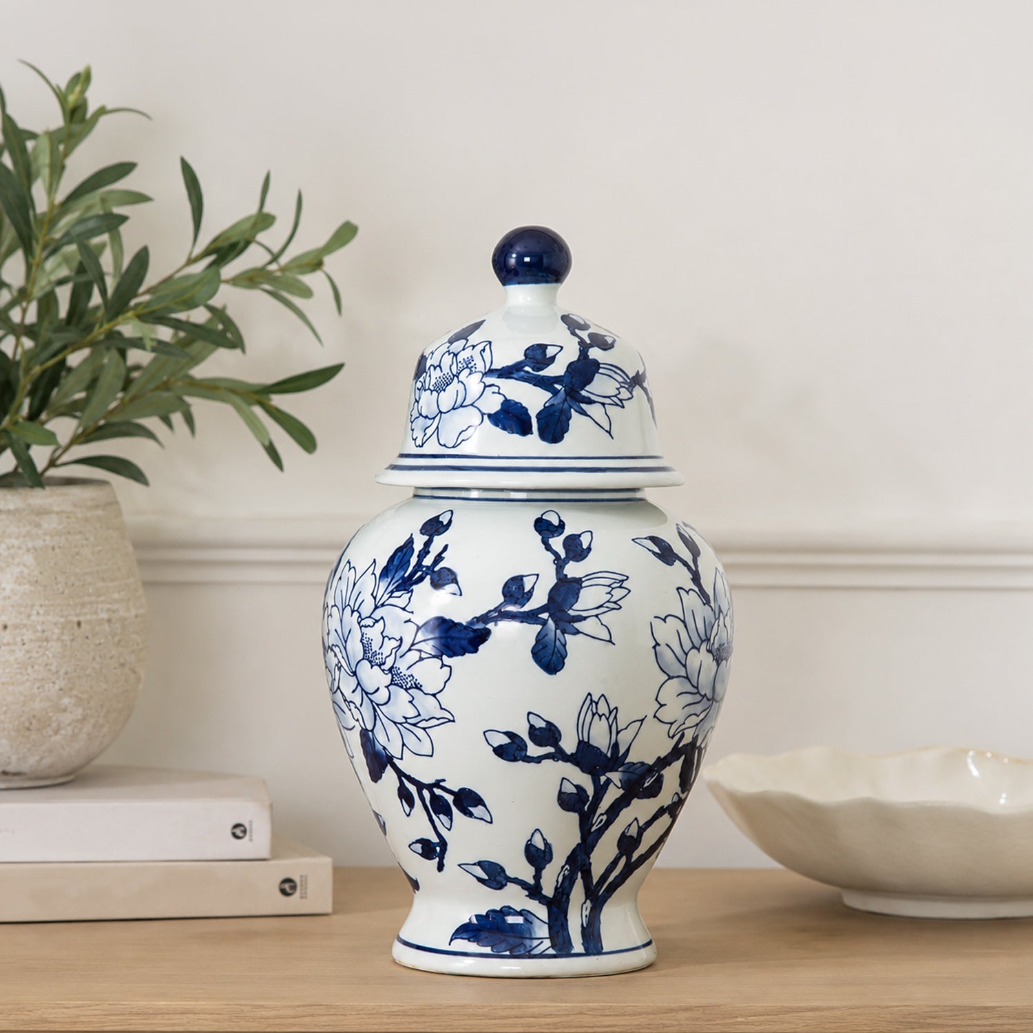 Gracious Living Magnolia Ginger Jar in blue and white, styled on a console with a classic floral design and rounded lidded shape.