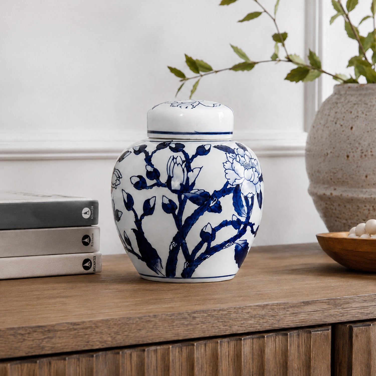 Gracious Living Magnolia Jar in blue and white, styled on a wooden console with a classic floral design and lidded top.
