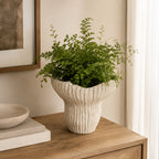 Design Republique Bulb Planter Natural styled with a green plant on a wooden sideboard.