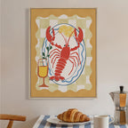 Design Republique Lobster Dish Framed Canvas styled on a kitchen wall above a breakfast setting, featuring a bright lobster, lemon and drink illustration.