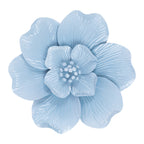 A light blue artificial flower with layered petals and a textured center, isolated on a white background.