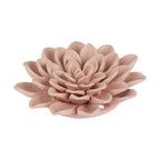 A dusty pink ceramic flower figurine with layered petals, photographed on a seamless white background.