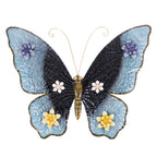 Blue and black metal butterfly wall hanging with decorative purple, pink and yellow floral details.