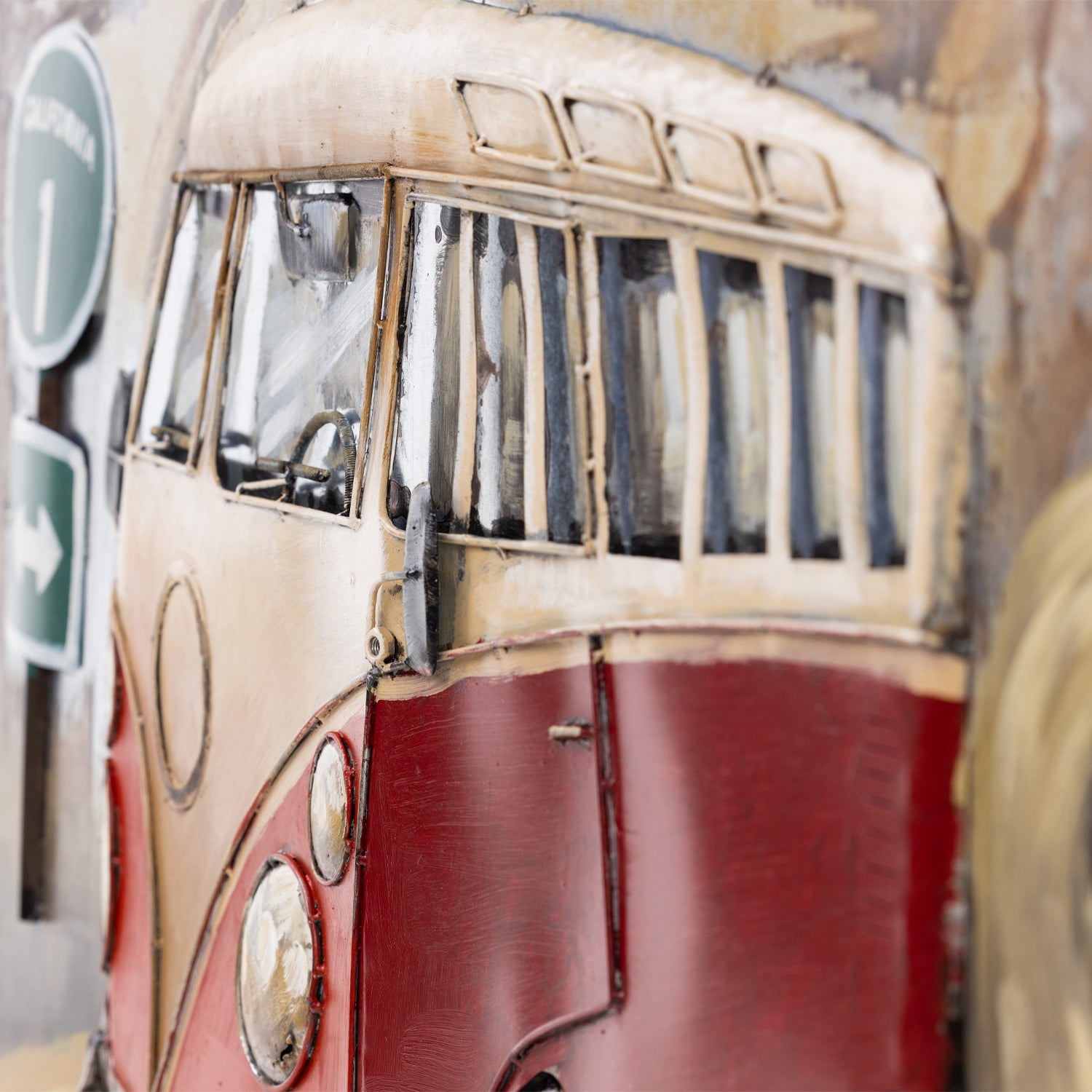 Close-up of the Kombi metal wall art showing the raised van windows, layered metal details and distressed painted finish.