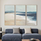 Lifestyle image showing the Cove On the Beach Framed 3 Piece displayed together above a blue sofa in a contemporary living room.