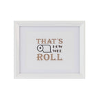 A white-framed typographic wall art print with the phrase “THAT’S HOW WEE ROLL” in tan and dark gray lettering on a white mat, shown against a light gray background.