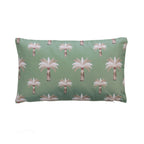 An outdoor cushion featuring a repeating palm tree pattern on a sage green background, with white and neutral fronds and brown trunks.