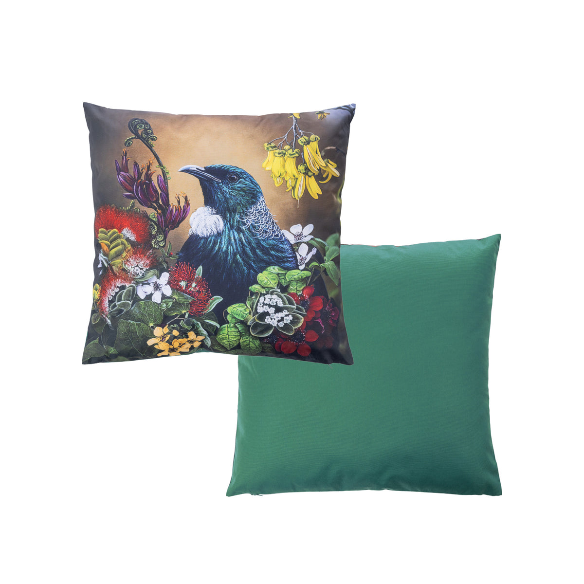 An outdoor cushion front and reverse features a detailed print of a Tui bird among colorful flowers on a warm background, while the reverse pillow shows a solid green fabric surface.