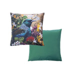 An outdoor cushion front and reverse features a detailed print of a Tui bird among colorful flowers on a warm background, while the reverse pillow shows a solid green fabric surface.