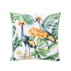 An outdoor cushion featuring a tropical print of two crowned cranes surrounded by green palm and monstera leaves and bright orange flowers on a white background.