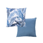 An outdoor cushion front and reverse features a blue tropical leaf pattern on a white base. And a plain blue reverse.