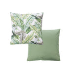 An outdoor cushion features a botanical leaf pattern in green tones on a white base, while the reverse is a solid green color.