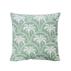 An outdoor cushion featuring a tropical palm print in white & green on a white background.