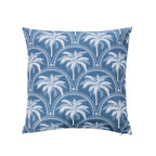 An outdoor cushion featuring a tropical palm print in white & blue on a white background.