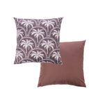 An outdoor cushion features a palm tree pattern in white & mocha while the reverse is a solid mocha color.