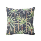 An outdoor cushion featuring a tropical palm tree pattern on a dark charcoal background, shown against a plain white studio backdrop.