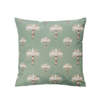 An outdoor cushion featuring a repeating palm tree pattern on a green background, with white and beige fronds and brown trunks, shown against a plain white background.