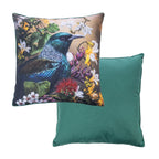 An outdoor euro cushion featuring a detailed print of a Tui bird surrounded by native flowers on a warm background, while the reverse of the cushion shows a solid green fabric.
