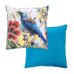 An outdoor euro cushion features a colorful print of a tui bird perched among native flowers, while the reverse of the cushion shows a solid bright blue.