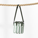 A small striped cooler bag with a dark green strap hangs from a thick rope against a plain white background.