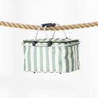 A rectangular folding cooler basket with a stripe print, suspended by a black handle from a thick natural rope against a clean white background.