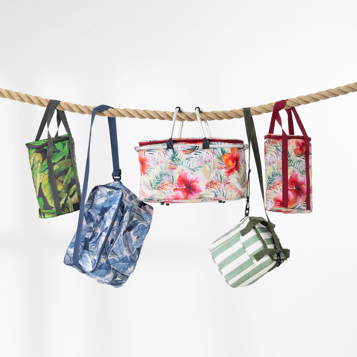 A range of cooler bags hanging from a thick rope against a plain white background. 