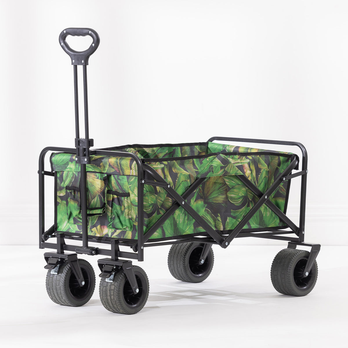 Havana green leaf-print beach trolley with black metal frame, four wide wheels and an extended pull handle.