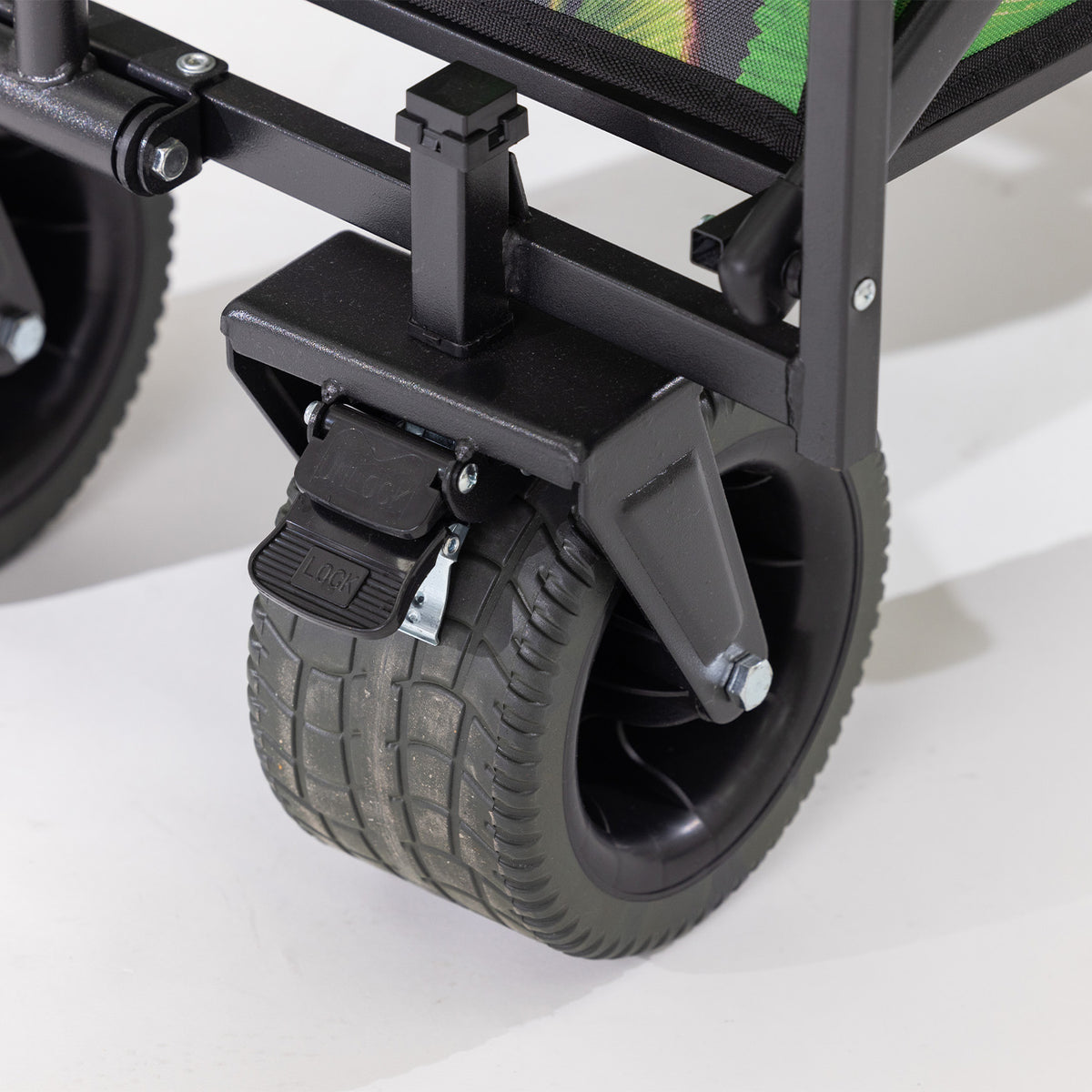 Close-up of the beach trolley’s wide black wheel with locking brake.