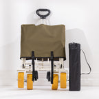 Folded green trolley shown with its pull handle extended, yellow wheels visible and black carry bag beside it.