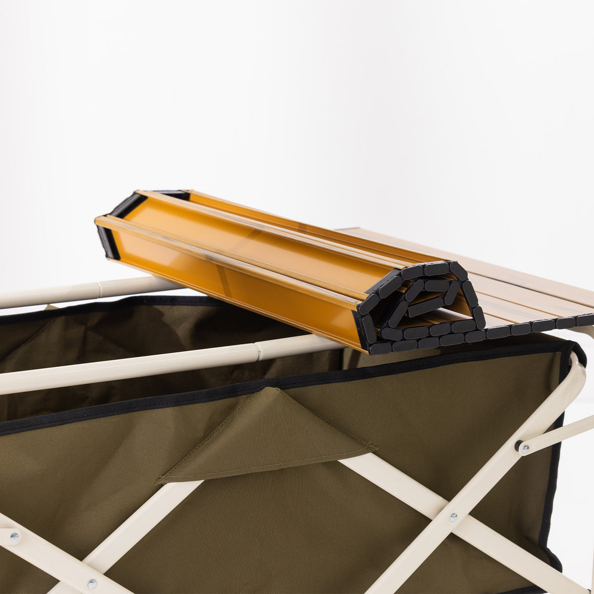 Folded slatted tabletop shown resting on top of the green trolley.