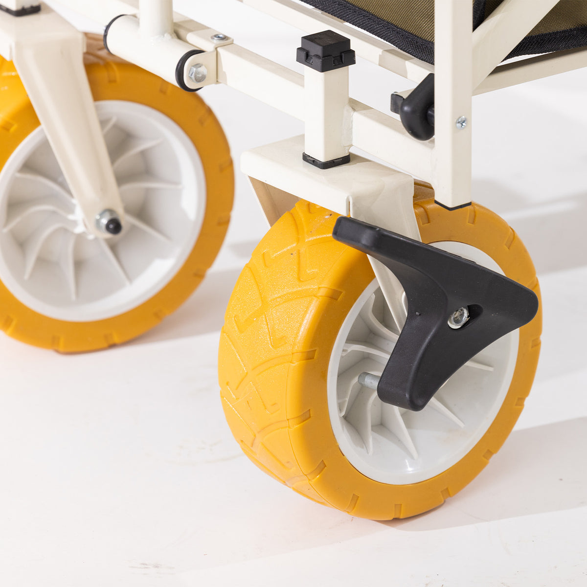 Close-up of the trolley’s yellow all-terrain wheel and black locking brake mechanism.