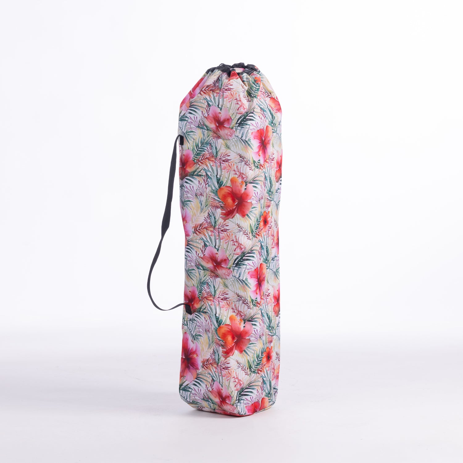 A drawstring moon chair bag with a vibrant tropical floral print in pink, red, green, and white, featuring a black carrying strap, set against a plain white background.